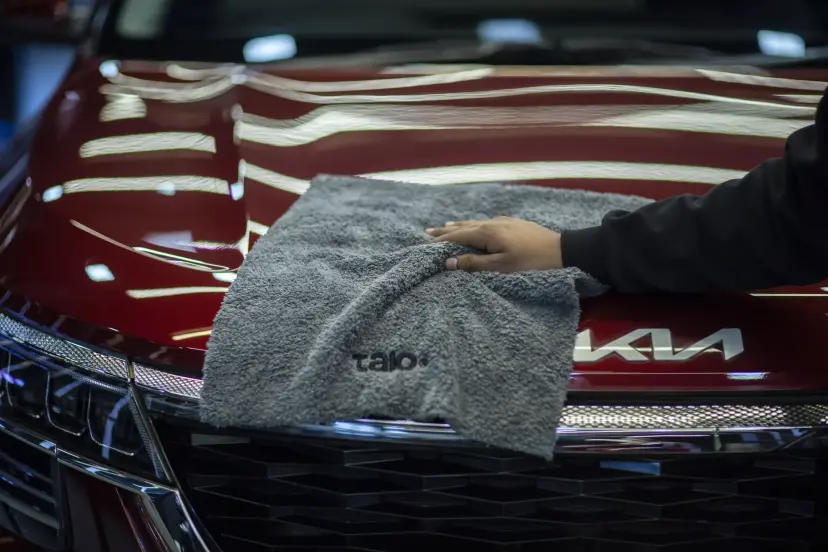 Talo towel on a red car bonnet