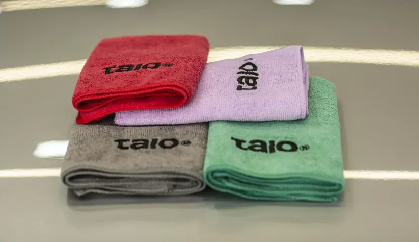 Red, pink, green and grey Talo Basic towels laid out side by side