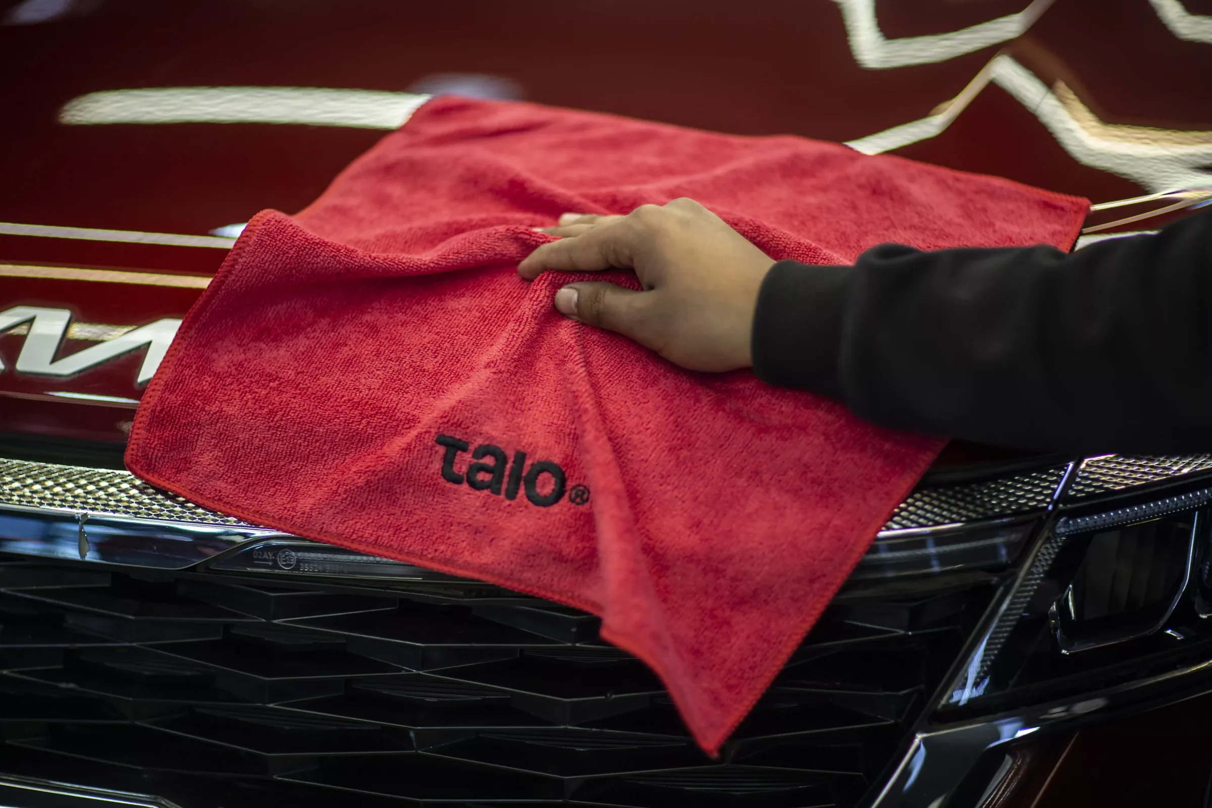 Red Talo Basic towel on a car